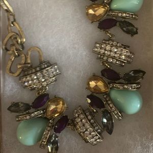 Necklace with gold, teal and purple jewels.